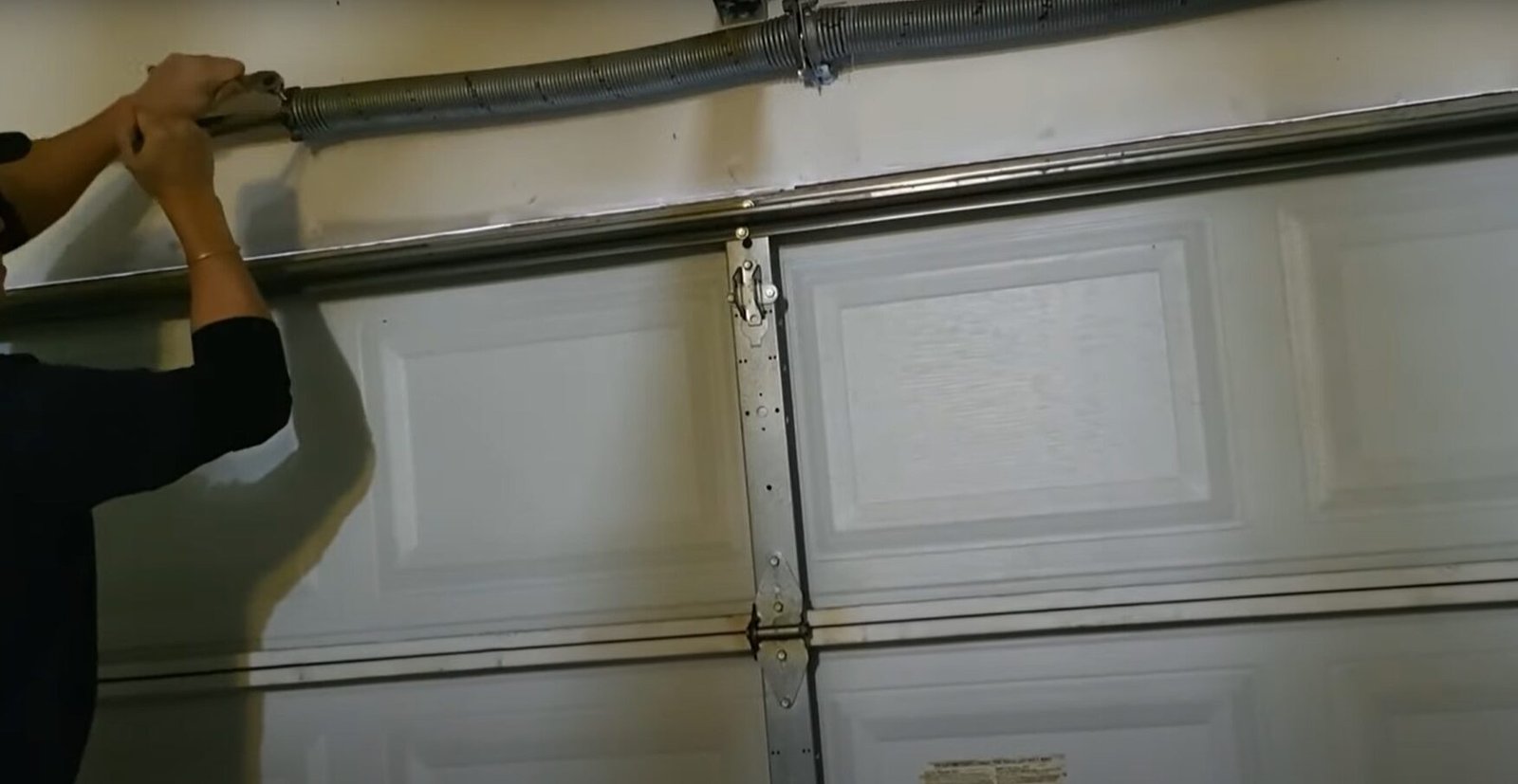 Close-up of a technician performing garage door spring repair in Osprey, ensuring safety and functionality for homeowners