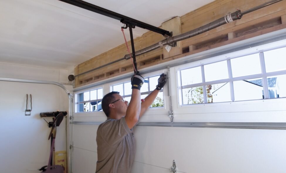 Close-up view of a technician performing garage door spring repair in Osprey, highlighting the precision and care taken in ensuring optimal garage door functionality.