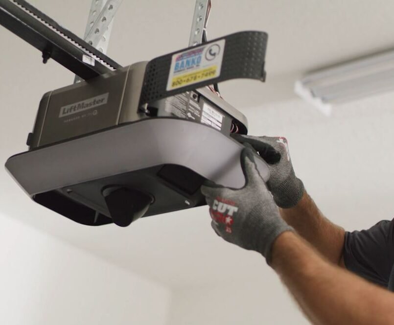 a professional technician performing garage door opener repair in Osprey, demonstrating precision and expertise in ensuring smooth garage door operation.